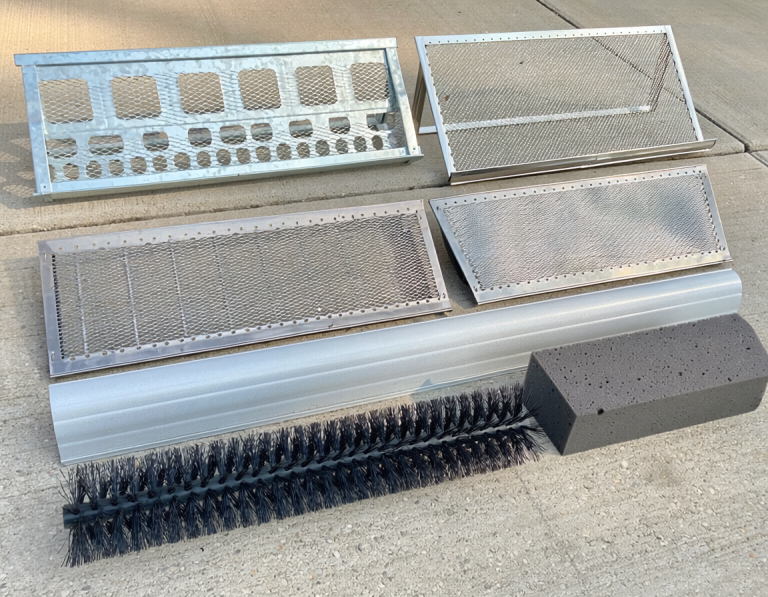 Six different gutter guard sample sections arranged on a clean driveway, including screen, mesh, micro-mesh, reverse-curve, brush, and foam types.