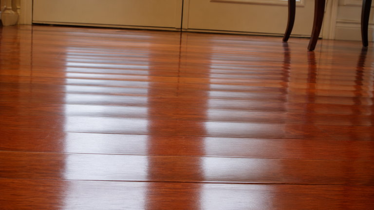 Cupped hardwood flooring with board edges raised slightly higher than the centers.